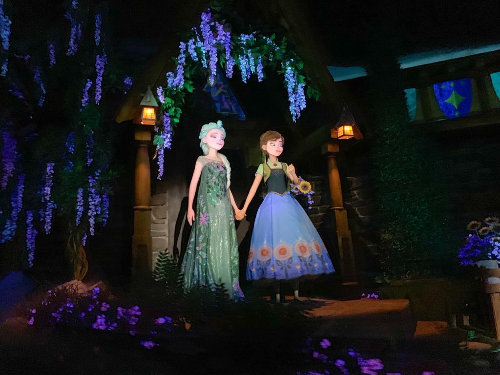 two animatronics of women in colorful dresses 